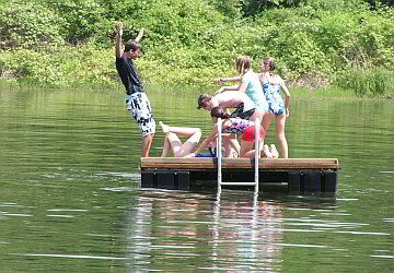 teens playing on swimming platform